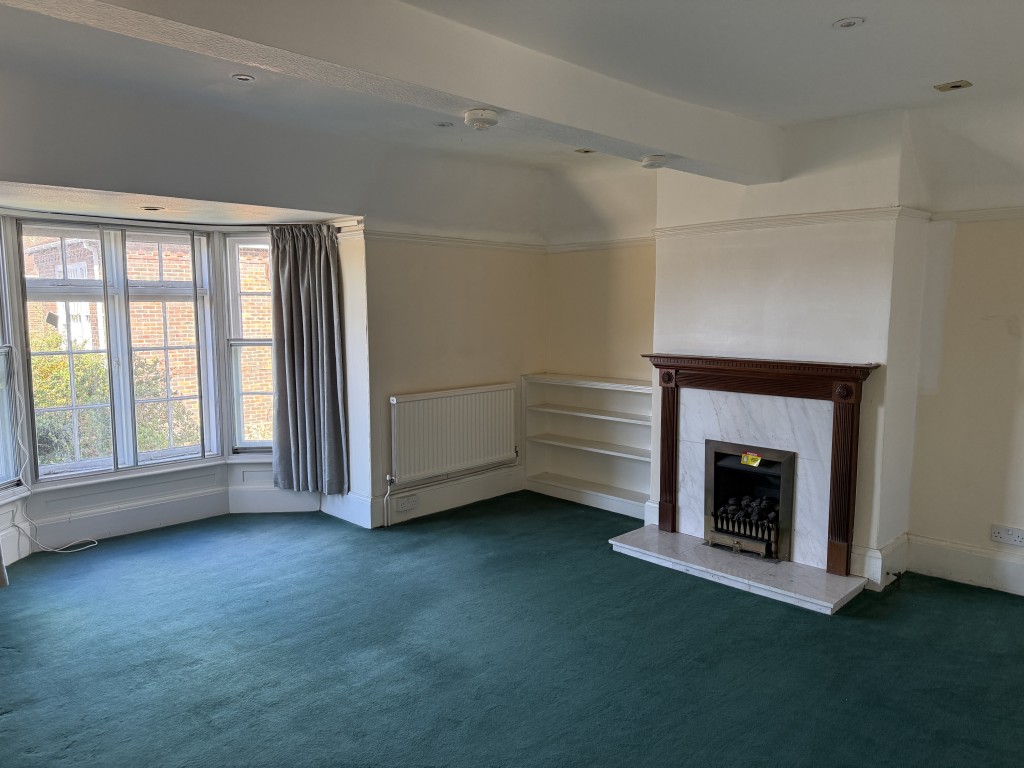 Lot: 192 - TWO-BEDROOM FLAT IN NEED OF IMPROVEMENT - Living room with carpet and painted walls